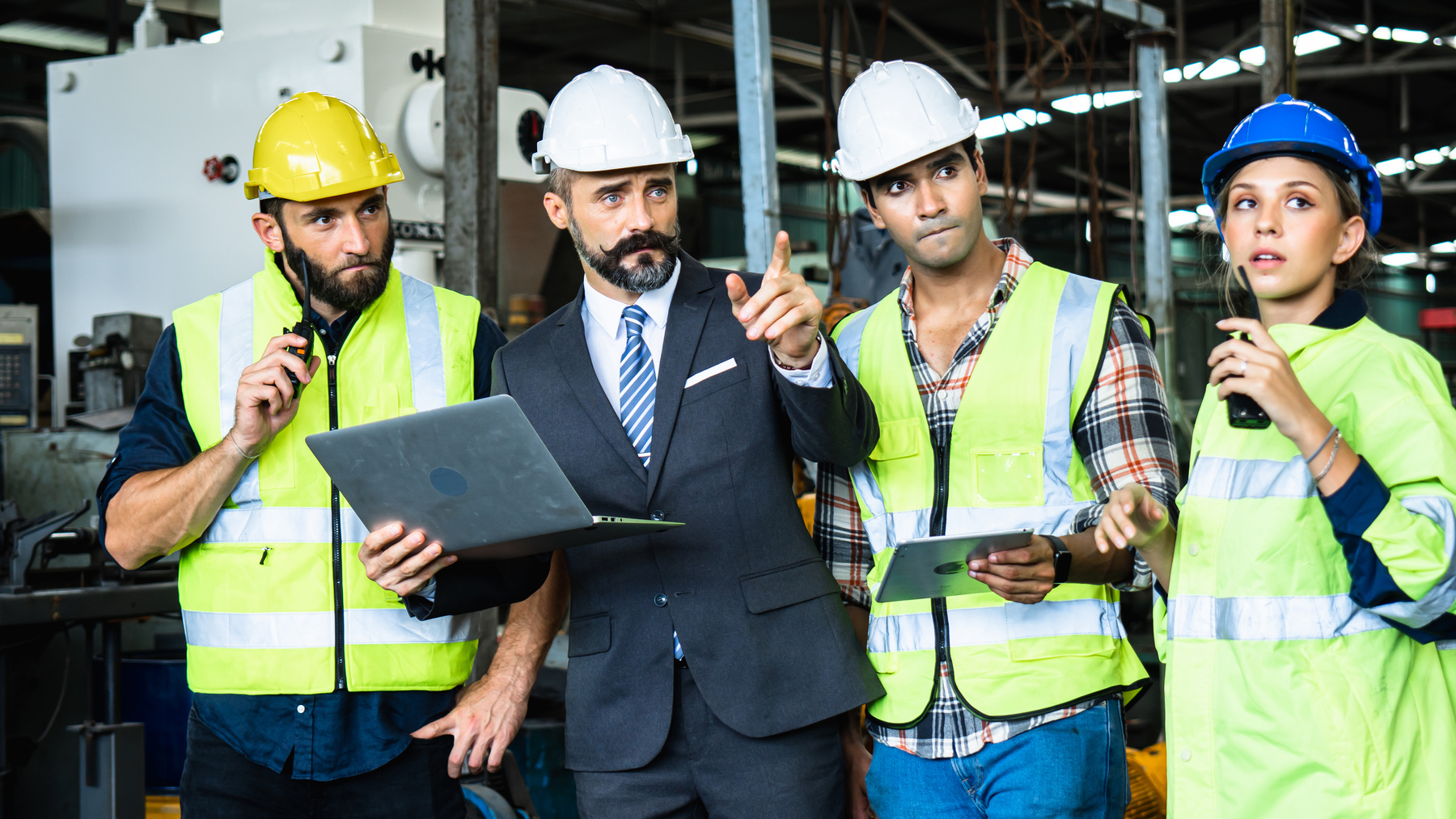 Industrial Engineer in Suite and Safety Helmet Working in Factor